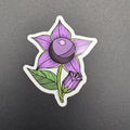 Sticker of a purple flower with green leaves on a gray background
